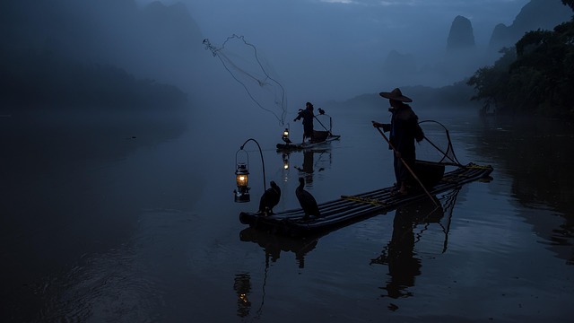 Guilin in mist, green towers rising above the river like unfinished thoughts