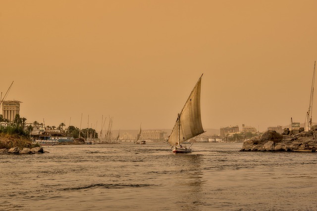 Nile evenings with temple outlines, slow boats, and air still warm from day